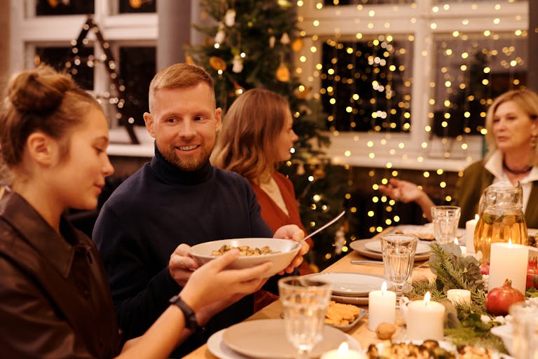 A joyful family gathering during Christmas with festive decorations and a delicious meal.